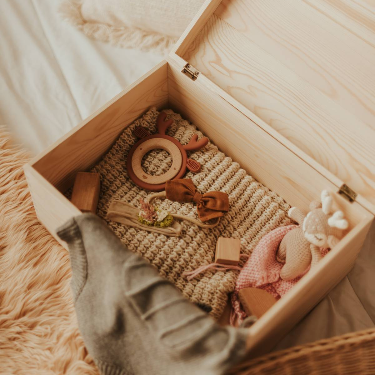 Open baby keepsake box with baby memories and accessories