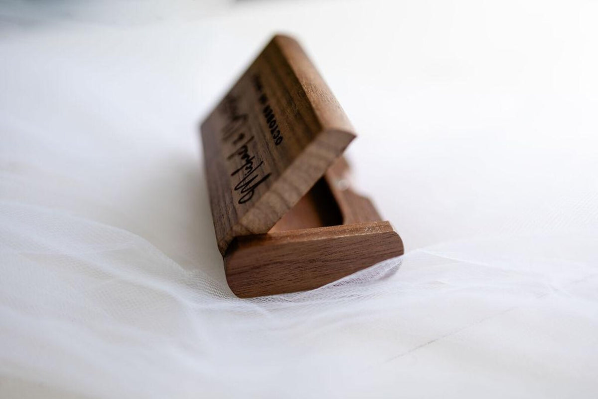 Open dark wood USB memory box displaying its fitted interior for storing a USB drive.