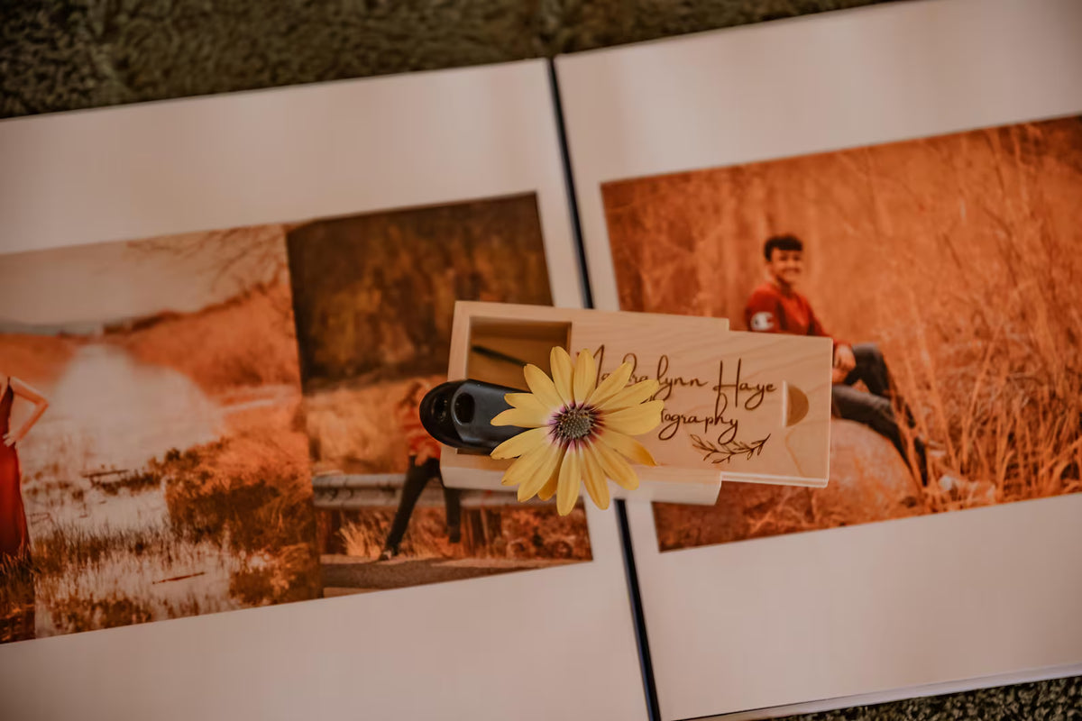 Personalized wooden USB box beside printed wedding photographs for preserving digital wedding memories.
